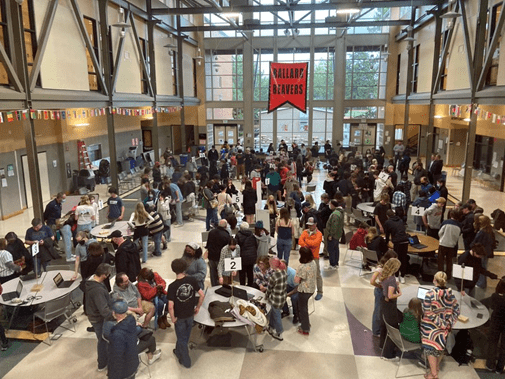 Ballard High School Misinfo Night presentations set up in an atrium at Ballard High School with students and adults exploring displays..