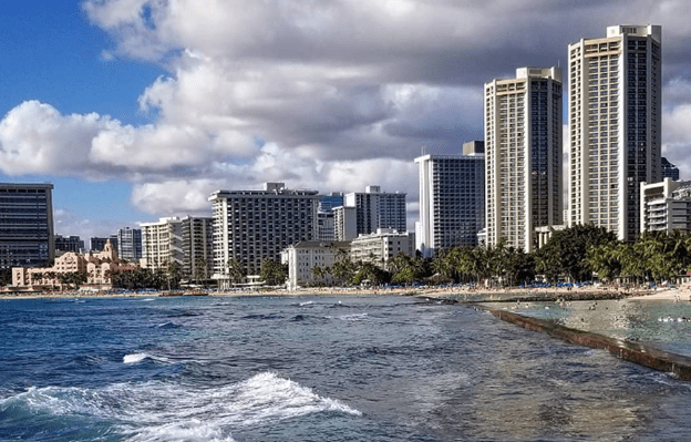 A photo of Waikiki beach in Honolulu, with a series of high rise towers framing the shot.