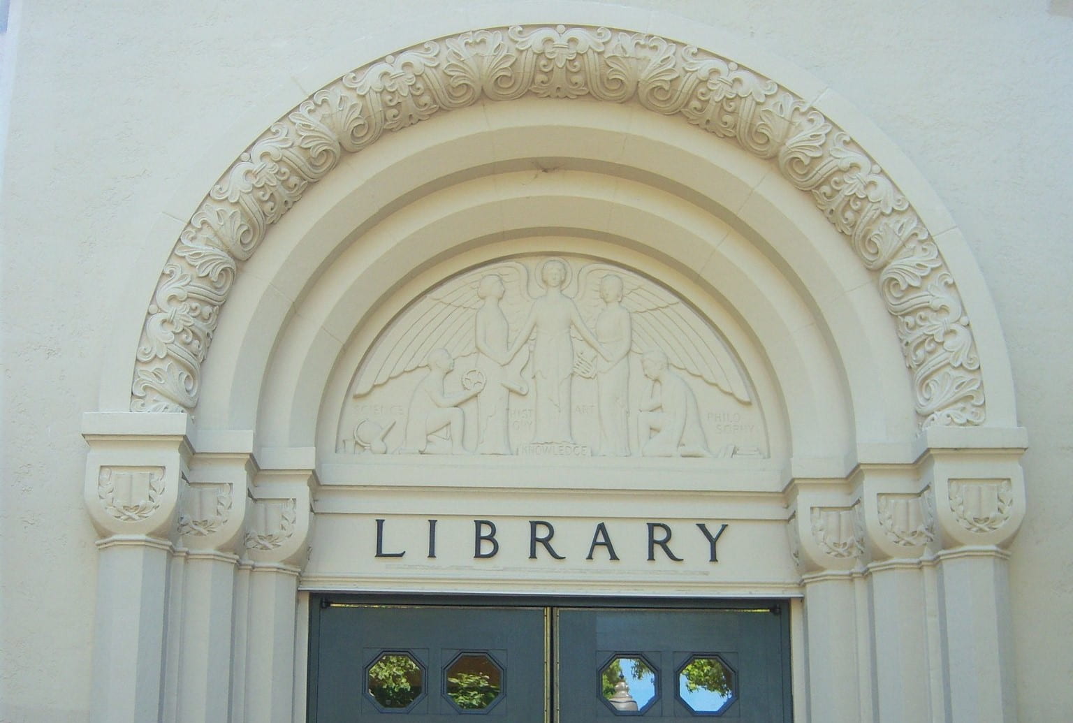 An arched entryway for a building that reads "Library"