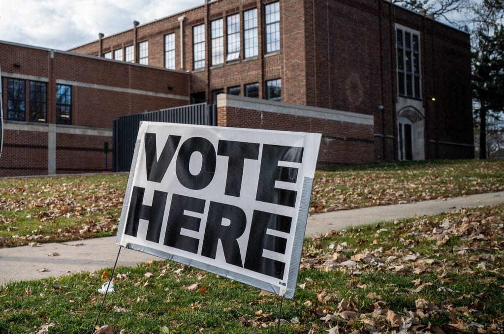 A "vote here" sign outside a school in Des Moines, Iowa. Photo by Phil Roeder / Flickr via CC BY 2.0 DEED.